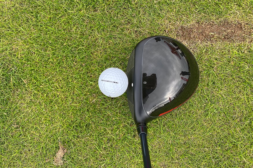 Wilson Dynapower Carbon driver addressing the golf ball view from above